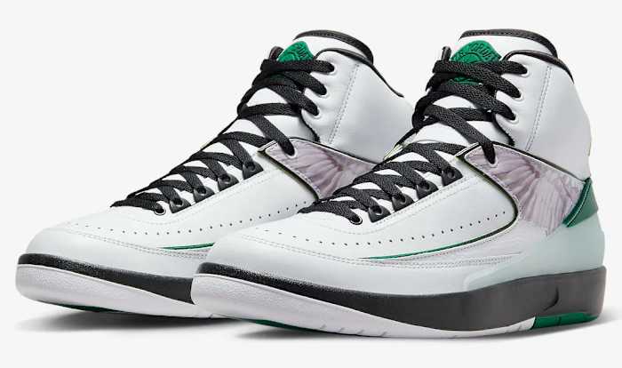 Side view of white, green, and black Air Jordan shoes.